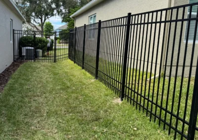 Black aluminum fencing standing 6 feet tall with four sturdy rails, designed to securely contain larger dogs while providing a sleek and durable enclosure.