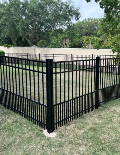 Aluminum fencing for puppy safety, with double-spaced pickets at the bottom, designed to prevent small dogs from squeezing through while maintaining an open and stylish look.
